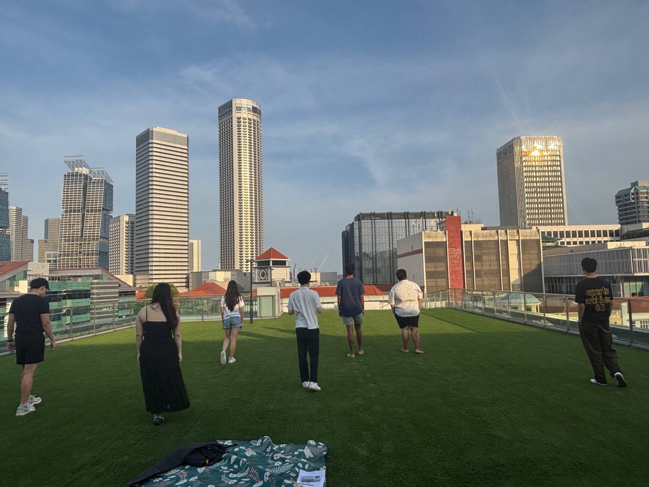 Group of volunteers on rooftop engaged in mindful walking